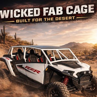 Off-road vehicle with Wicked Fab Cage in desert.