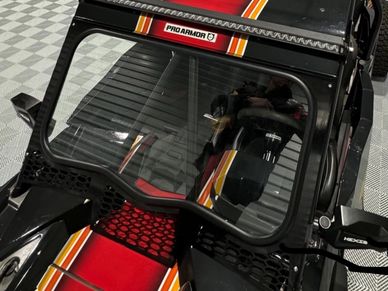 Close-up of a Pro Armor vehicle windshield with striped detailing.