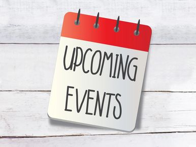 A notepad with 'Upcoming Events' written on it against a white wooden background.