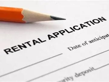 A pencil resting on a rental application form.