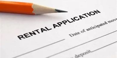 Close-up of a rental application form and an orange pencil.