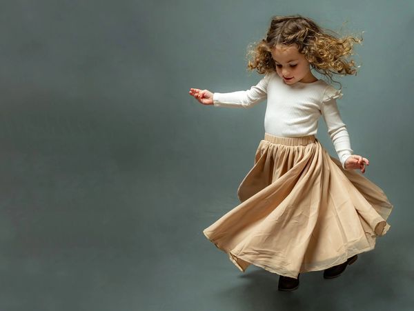 Fine Art Children's Portrait editorial vibe Charleston SC Girl spins skirt twirls 