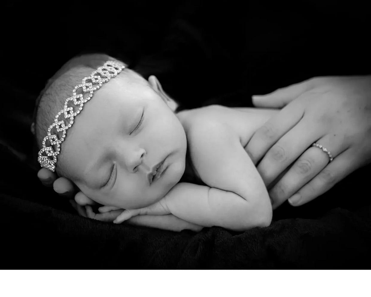 Charleston newborn portrait of baby held gently in parent hands