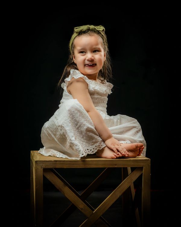 Fine Art Children's Portrait editorial vibe Charleston SC girl white dress looks over shoulder