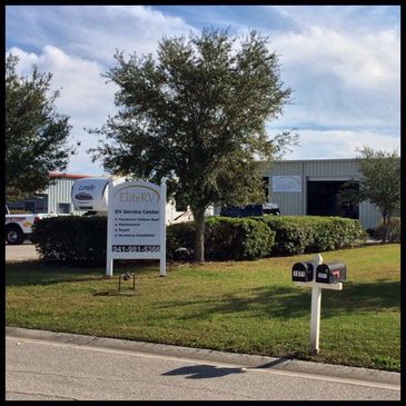 Exterior of Elite RV Service Center with sign and mailboxes.