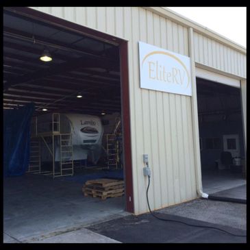 Exterior view of Elite RV workshop with an RV inside.