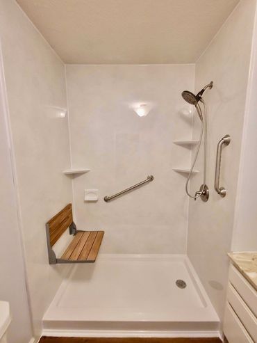 Walk-in shower with fold out shower seat and grab bars