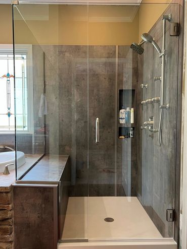 Jacuzzi Bath Remodel featuring a walk-in shower with textured urban shower walls