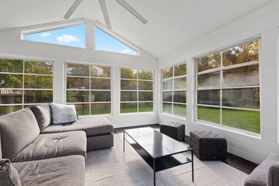 three seasons room with 5 windows and outside patio furniture