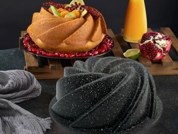 Two bundt cakes with fruit and juice.