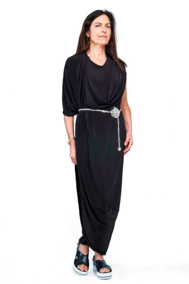 Woman in a stylish black dress with a silver belt and platform sandals.