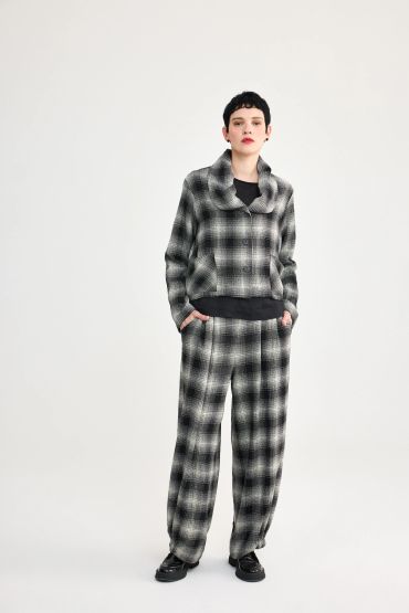 Person wearing a black and white plaid outfit.