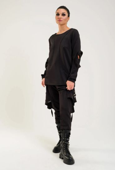 Woman in stylish black outfit and boots.