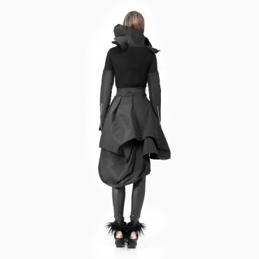 Back view of a fashion model in avant-garde black outfit.