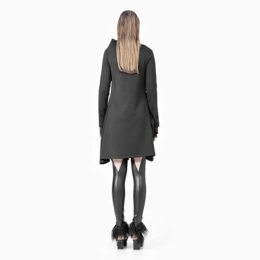 Woman in black dress and shiny black stockings with feathered heels.