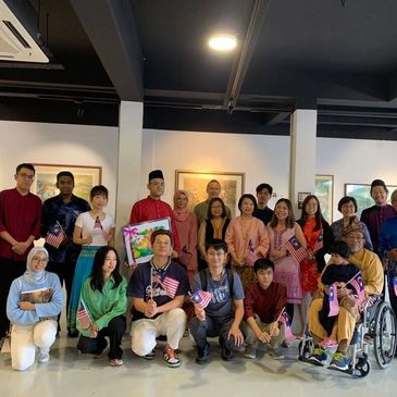 A group of diverse artists smiling and posing happily at Inner Joy Art Gallery. 