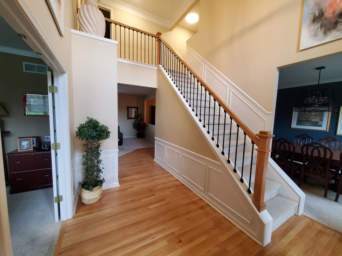 beautiful remodel of home with new hardwood floor, carpet, and stair railing.