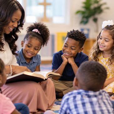 Teacher reading to children in a classroom.