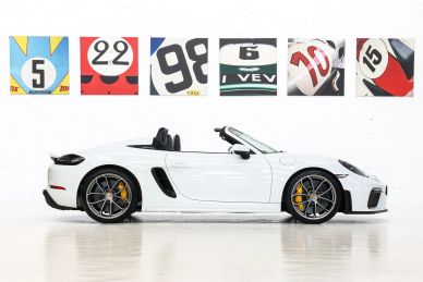 White convertible sports car with racing number artwork.