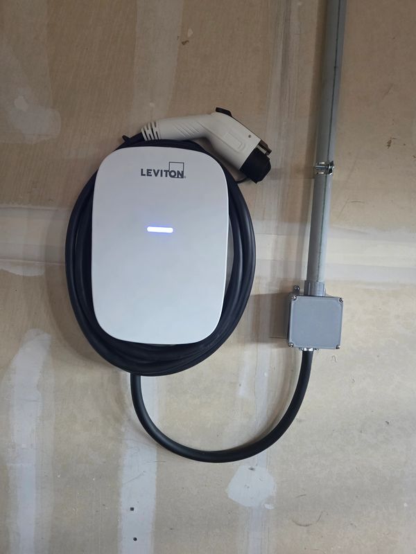 Leviton electric vehicle charging station mounted on a wall.