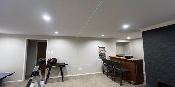 Basement room with furniture and a laser level line.