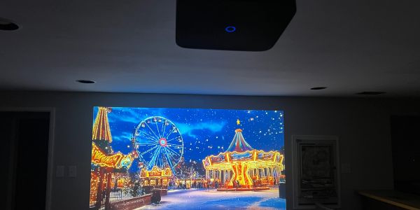 Indoor projection of a bright carnival scene at night.