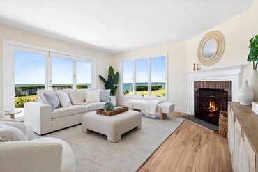 Hamptons home staging -- living room in waterfront home staged in neutral colors with a pop of blue.