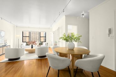 Image of NYC home staging living/dining room, with autumnal colors.