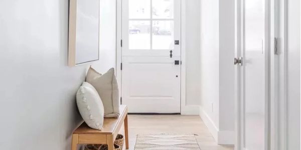 Image of white entry way with simple beige accents.