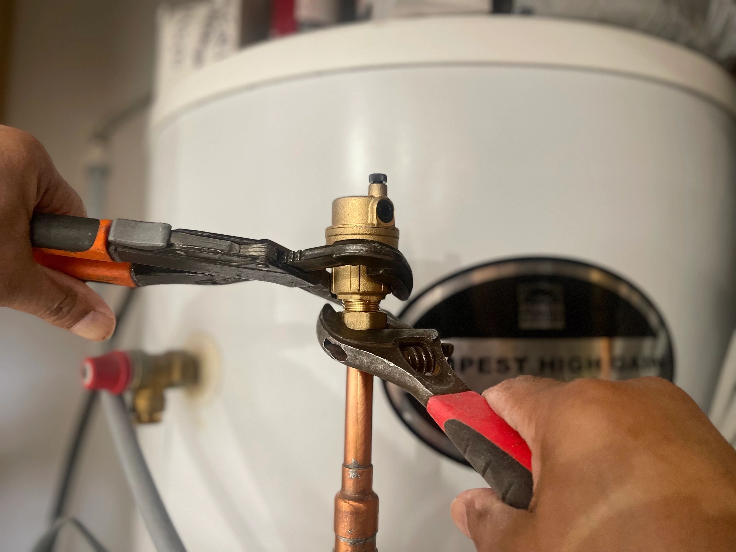 A guy putting an automatic air valve on to a circuit