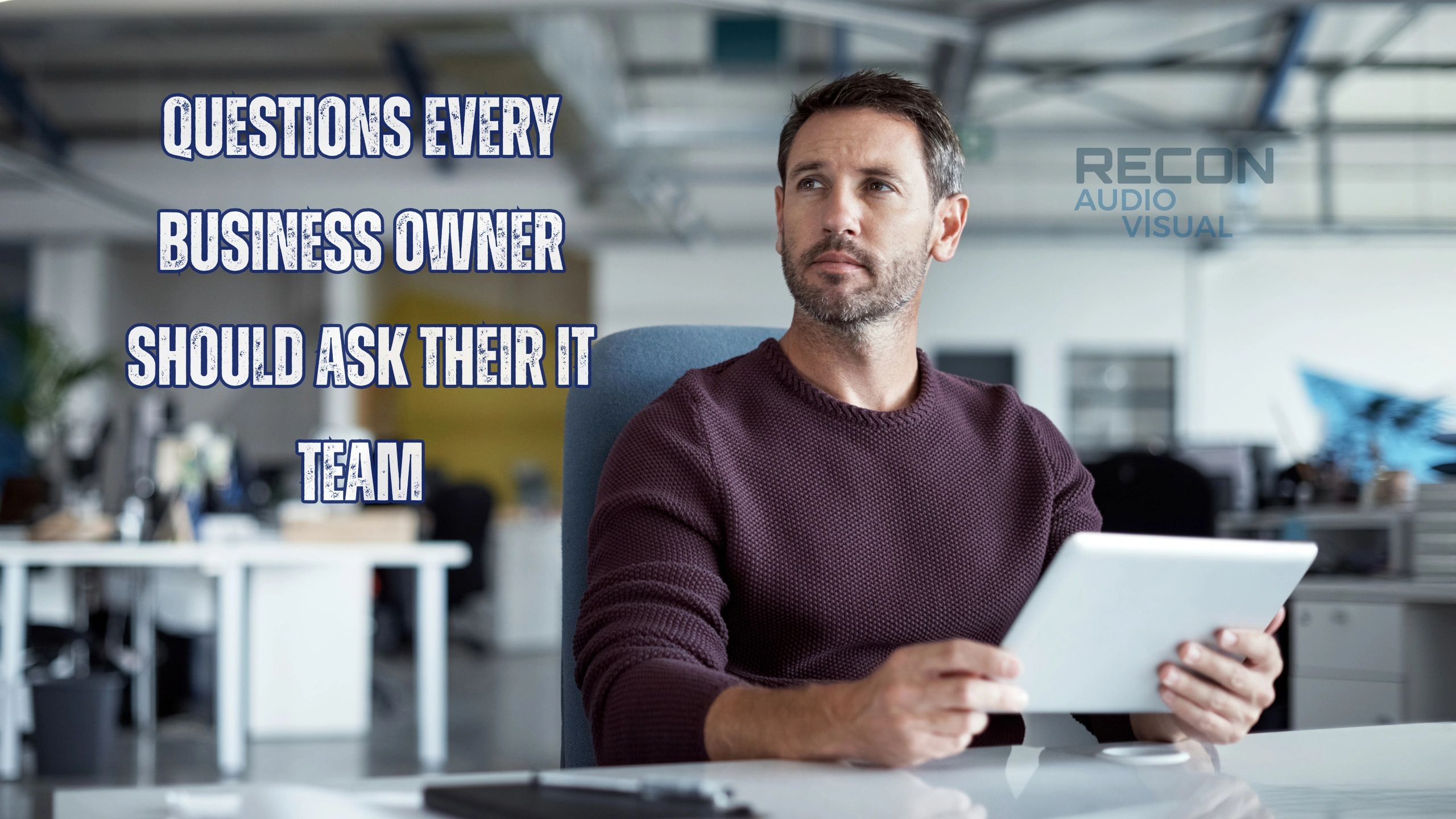 Businessman holding a tablet with text about IT questions for business owners.