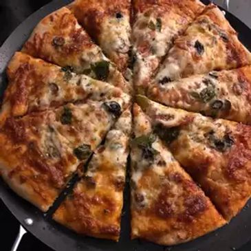 Cheese and vegetable pizza sliced into eight pieces.
