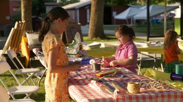 Children making crafts in the kid zone at Kingsburg Historic Park.