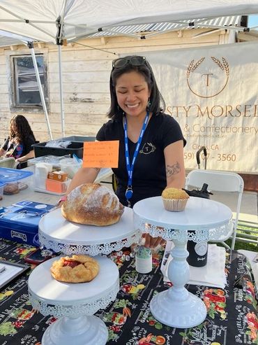 Tasty Morsels' booth with sourdough and fresh stone fruit galletes.