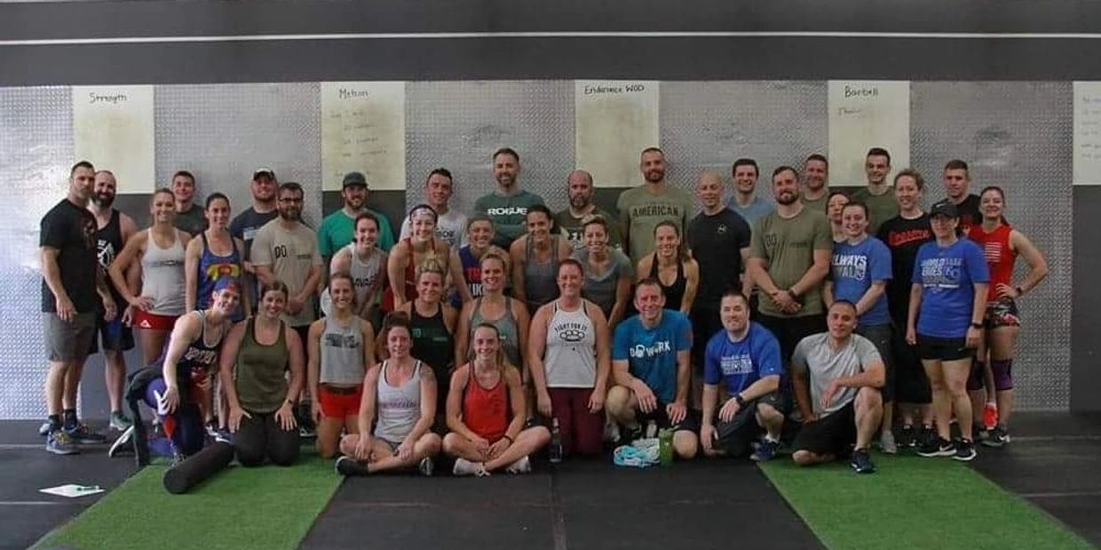A happy group of crossfit people in a gym