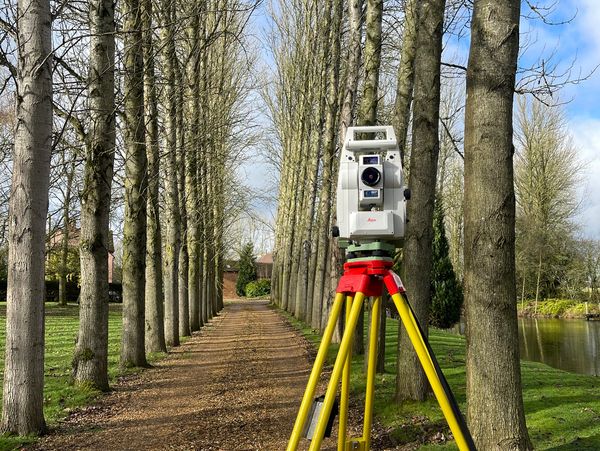Surveying equipment on a forest path.