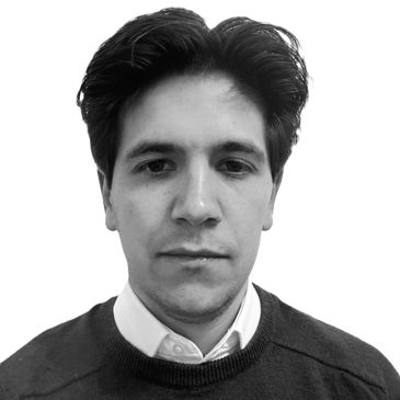 Black and white portrait of a serious man with dark hair.
