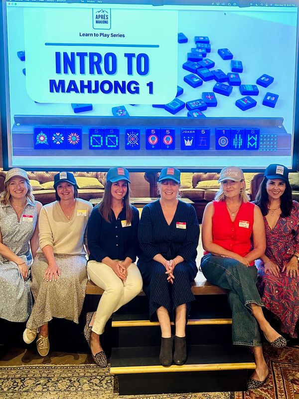 Apres Mahjong instructors teaching and introduction to mahjong class at a corporate event.