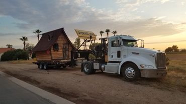 386 Peterbilt hauling a whimsical shed. 