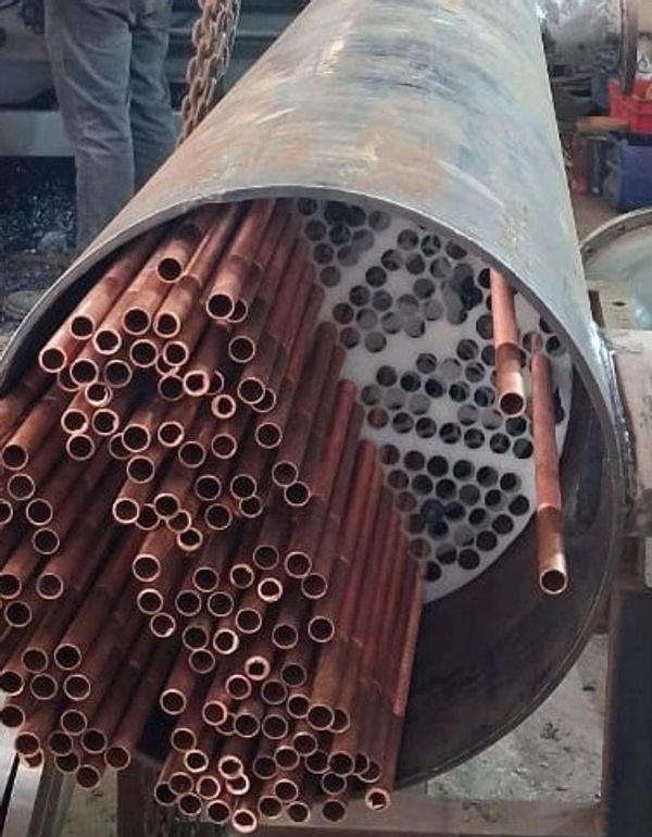 Bundle of copper tubes inside a large metal cylinder.