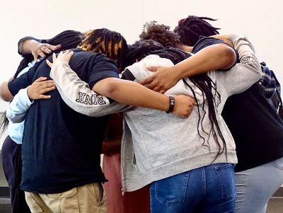 Group of Teens huddled together for a group hug