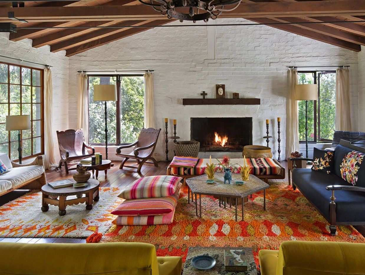 Cozy living room with fireplace and colorful cushions.