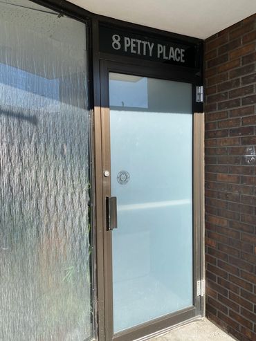 Frosted glass door and entrance at 8 Petty Place.