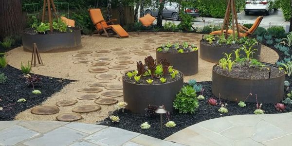 Modern garden with raised planter beds and lounge chairs.