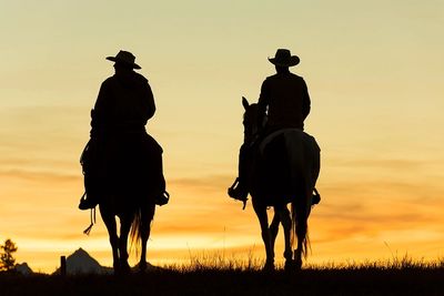 Cattlemen in Oklahoma sunset