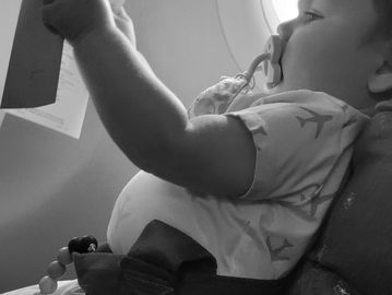 Nanny Thaty and baby on a plane during an international flight