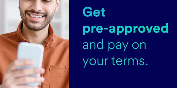 Smiling man using phone with text about getting pre-approved and paying on your terms.