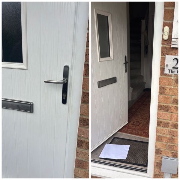 White front door with letterbox, open to reveal a doormat and an envelope inside.