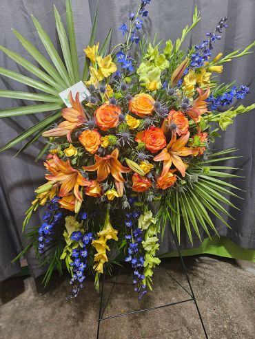 Vibrant floral arrangement with orange, yellow, and blue flowers.