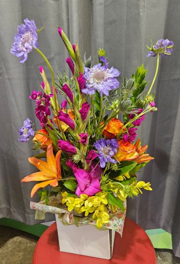 Colorful bouquet of flowers in a white vase.